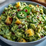 Creamy guacamole with mango and jalapeño, a vibrant dip perfect for Cinco de Mayo parties and festive gatherings.  