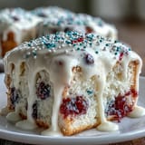 Festive Patriotic Poke Cake showcases vibrant colors, a moist cake, and smooth ganache topping.