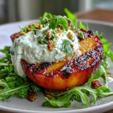 Creamy burrata salad with juicy grilled peaches, drizzled with honey dressing.