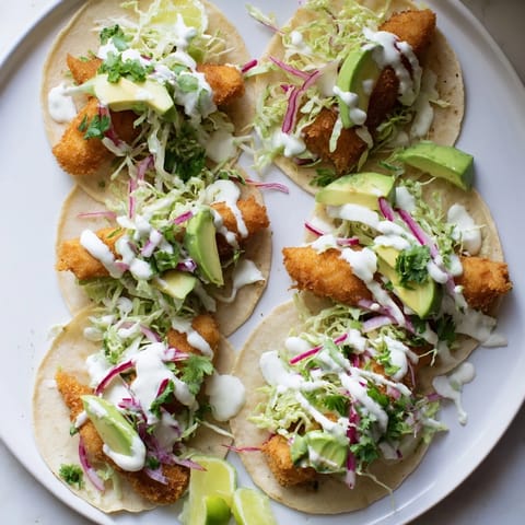 Crisp fried fish tacos topped with crunchy slaw and fresh cilantro on warm corn tortillas.