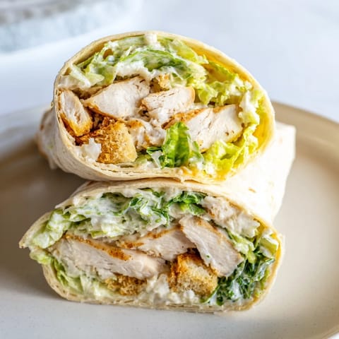 Caesar Chicken Salad Wrap served with a side salad, perfect for a quick and satisfying lunch.