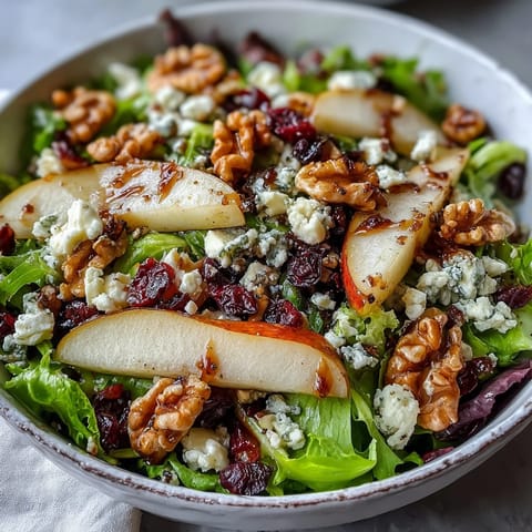 Freshly sliced ripe pears and crumbled Gorgonzola cheese atop a bed of mixed greens, topped with toasted walnuts and a honey-balsamic vinaigrette.