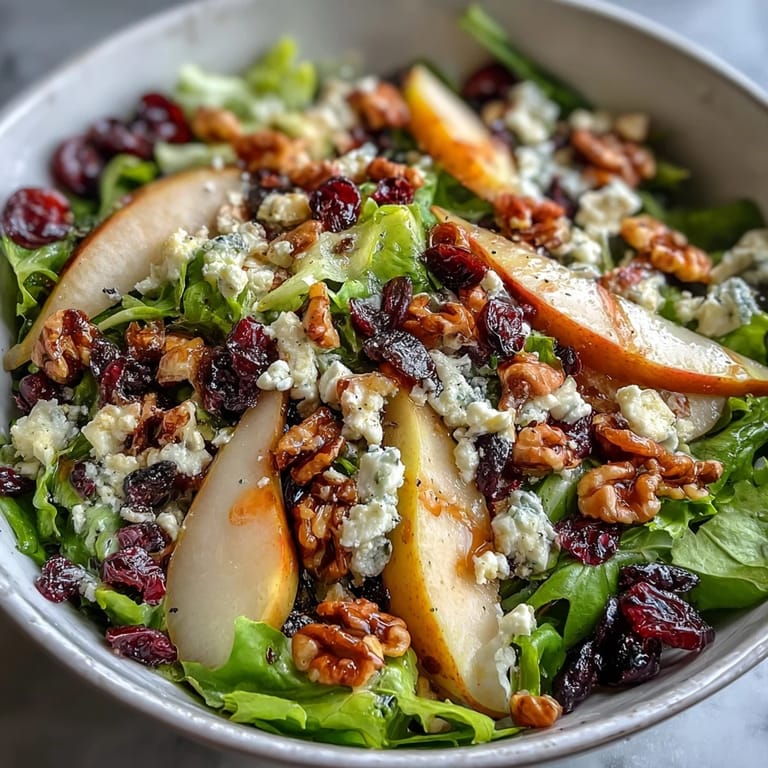 Pear Gorgonzola Salad featuring crisp greens, tangy blue cheese, sweet pears, and crunchy walnuts, served ready for a light vegetarian meal.