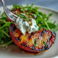 Grilled peach and burrata salad, showcasing caramelized peaches with creamy cheese.